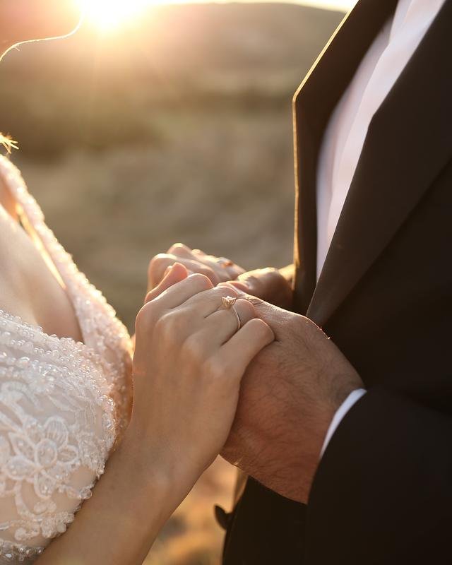 A couple holding hands in warm evening sunlight