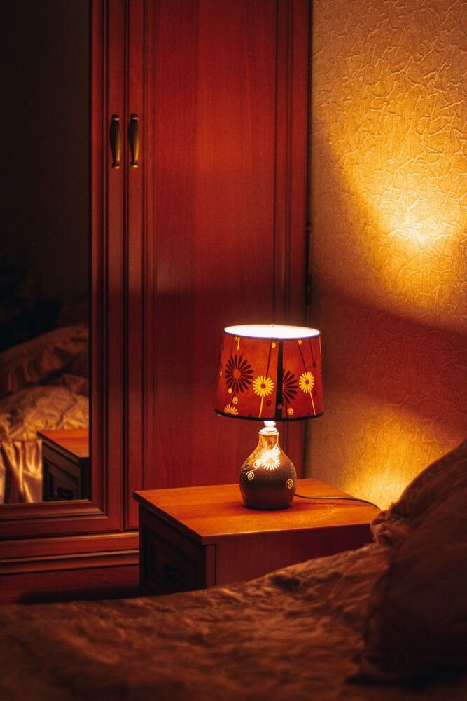 A bedside lamp lit in the evening
